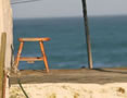 Step through your doorway, sit on a stool, and gaze at the azure sea. — at Waenhuiskrans/Arniston.